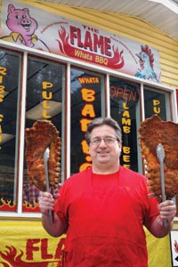 Flame BBQ owner Lou Kampi shows off his ribs.